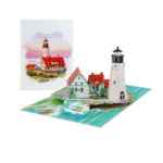 A custom landmark pop up card showcasing the scenic Oregon Coast lighthouse, colorful seaside houses, rocky cliffs, and blue ocean waves in an intricate 3D paper design.