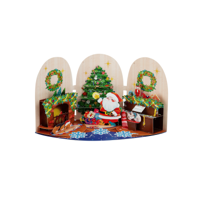 Handmade 3D Christmas pop up card with Santa in a cozy festive living room surrounded by Christmas wreaths, tree decorations, gifts, fireplace, and piano.