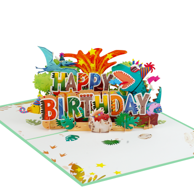 Dinosaur Happy Birthday Pop Up Card featuring colorful 3D dinosaurs, party decorations, tropical leaves, and large Happy Birthday lettering.